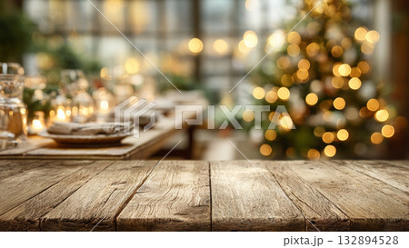 blank wooden table with blurred Christmas tree and festive dinner background blank wooden table with blurred Christmas tree and festive dinner background 132894528