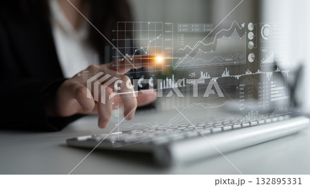 Business professional analyzing data trends on a digital screen while working on a laptop for financial decision making and strategic planning Scalp Business professional analyzing data trends on a digital screen while working on a laptop for financial decision making and strategic planning Scalp 132895331