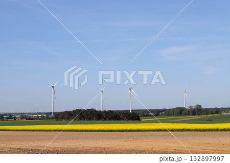 Wind Turbines on Green Field Under Clear Sky Wind Turbines on Green Field Under Clear Sky 132897997