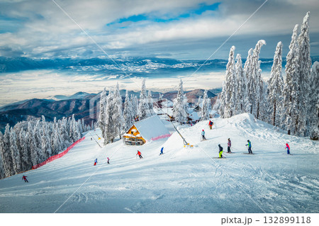 Skiers on the steep ski slope, Carpathians, Romania Skiers on the steep ski slope, Carpathians, Romania 132899118