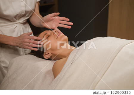 Relaxing facial massage at a wellness spa in the afternoon, focusing on rejuvenation and stress relief for a peaceful experience 132900330