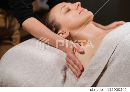 Relaxation during a soothing massage session in a tranquil spa environment for rejuvenation and stress relief Relaxation during a soothing massage session in a tranquil spa environment for rejuvenation and stress relief 132900343
