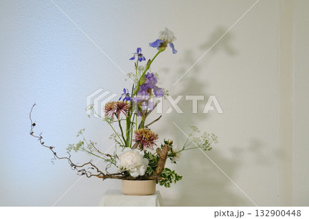 Stunning floral arrangement showcasing delicate blooms and elegant branches in a minimalist setting for spring celebration Stunning floral arrangement showcasing delicate blooms and elegant branches in a minimalist setting for spring celebration 132900448