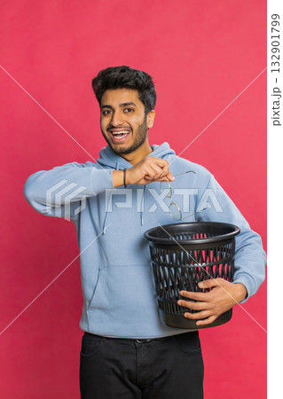 Man taking off, throwing out glasses into bin after medical vision laser treatment therapy surgery Man taking off, throwing out glasses into bin after medical vision laser treatment therapy surgery 132901799
