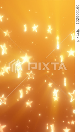 Glowing golden stars falling gently across a radiant orange background with festive light effects 132903160