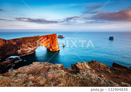Amazing black arch of lava standing in the sea. Location cape Dyrholaey, Iceland, Europe. 132904830