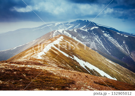 Gloomy view of the snow range under overcast sky. Location place Carpathian, Ukraine, Europe. 132905012