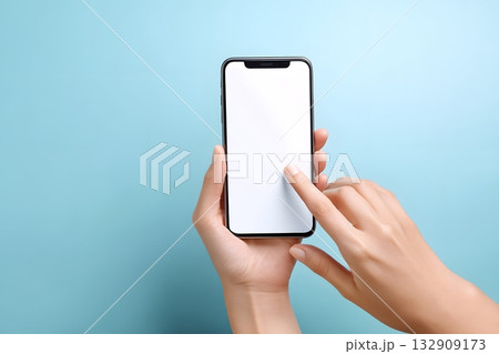 A hand holds a phone and touches the screen with a finger. 132909173