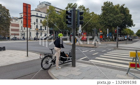 A unique shaped bicycle stopping at the red traffic sign on the sidewalk in Antwerp 132909198