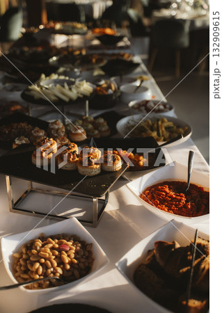 Elegant Buffet Table Setup with Assorted Appetizers 132909615