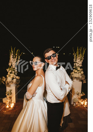 Newlywed Couple Celebrating with Fun Sunglasses at Night 132909618