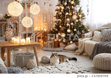 A cat rests near a Christmas tree and festive lights. 132909769
