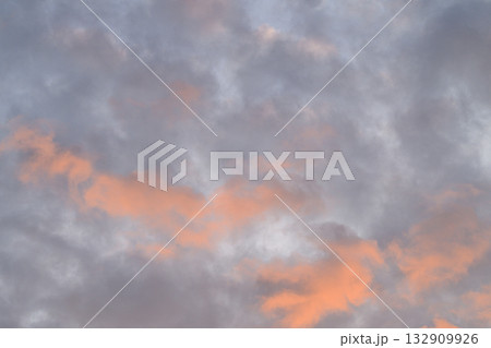 A Serene and Beautiful Cloudy Sky at Dusk Featuring Hints of Orange Color Specially 132909926