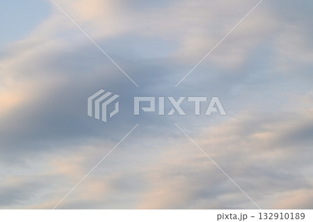 A Serene and Beautiful Sky with Soft, Fluffy Clouds During a Peaceful Dusk Setting A Serene and Beautiful Sky with Soft, Fluffy Clouds During a Peaceful Dusk Setting 132910189