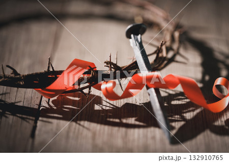 Crucifixion of Jesus Christ, nail-pierced hands, crown of thorns, cross, symbol of Christianity, representing holy sacrifice, passion, faith central to Easter celebration, religious tradition. 132910765