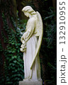 white angel sculpture in a cemetery 132910955