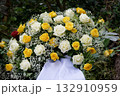 grave arrangement with white and yellow roses 132910959