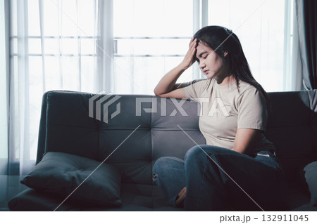 Sorrowful woman sat alone, overwhelmed by emotion, her sad and unhappy expression revealing deep despair, stress and distress left feeling depressed. sorrowful sad, despair alone, depressed stress Sorrowful woman sat alone, overwhelmed by emotion, her sad and unhappy expression revealing deep despair, stress and distress left feeling depressed. sorrowful sad, despair alone, depressed stress 132911045