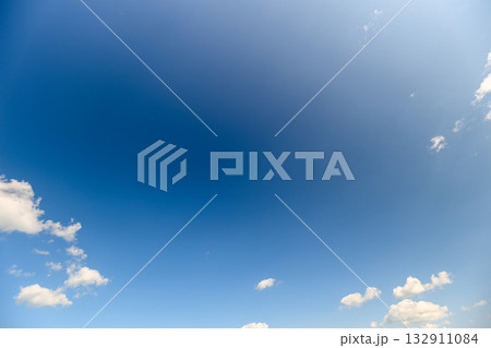 A Beautiful Clear Blue Sky Adorned with Fluffy White Clouds, Natures Delightful Canvas 132911084