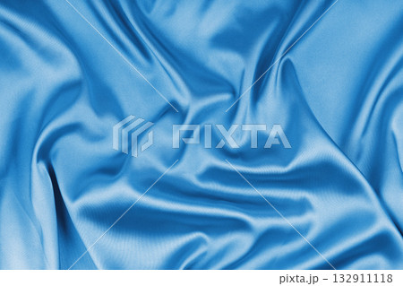 Crumpled, wrinkled cyan colored glossy silk satin texture. Shiny smooth fabric with soft folds Crumpled, wrinkled cyan colored glossy silk satin texture. Shiny smooth fabric with soft folds 132911118