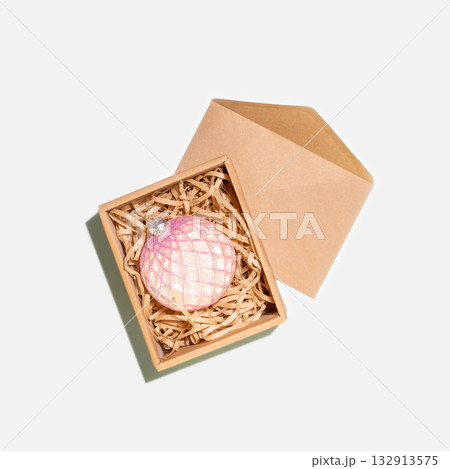 Christmas Ornament In Gift Craft Box With Craft Envelope. Holiday Packaging Concept For Eco-Friendly Presents, Handmade Decorations, And Seasonal Branding For Sustainable Celebrations Christmas Ornament In Gift Craft Box With Craft Envelope. Holiday Packaging Concept For Eco-Friendly Presents, Handmade Decorations, And Seasonal Branding For Sustainable Celebrations 132913575