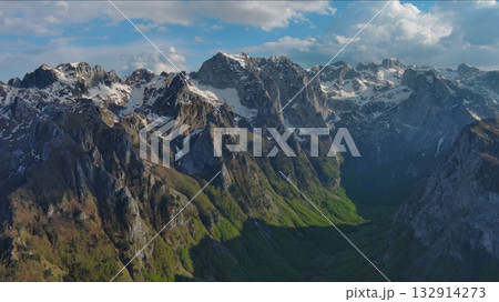 Rocky snow mountains before sunset aerial 132914273