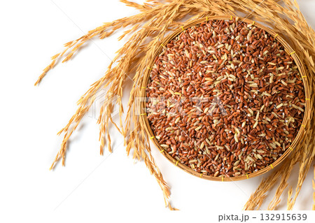 Organic Brown Rice in Basket with Golden Rice Ears on White Background 132915639