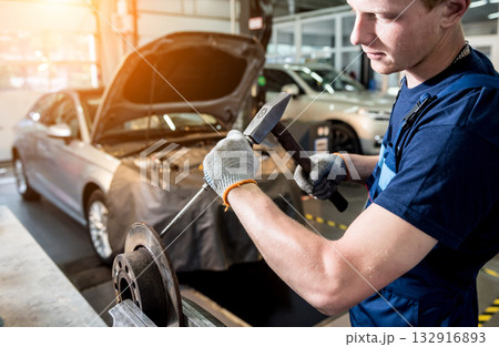 Car mechanic repair car brakes at service station. Car repair service Car mechanic repair car brakes at service station. Car repair service 132916893