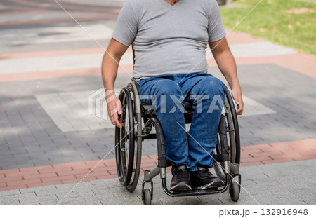 Handicapped man in wheelchair walk at the park alley Handicapped man in wheelchair walk at the park alley 132916948