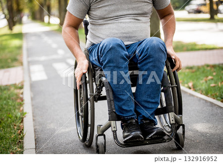 Handicapped man in wheelchair walk at the park alley Handicapped man in wheelchair walk at the park alley 132916952