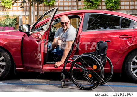Young handicapped man on driver's seat of his car Young handicapped man on driver's seat of his car 132916967