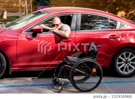 Young handicapped man on driver's seat of his car Young handicapped man on driver's seat of his car 132916968