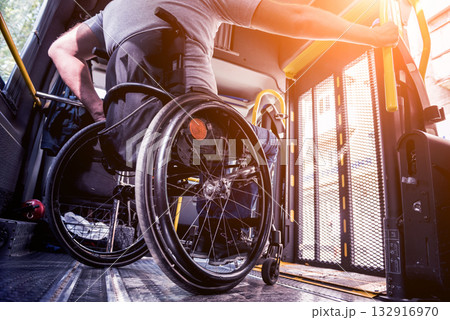 A man in a wheelchair inside of a specialized vehicle A man in a wheelchair inside of a specialized vehicle 132916970