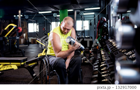 Disabled man training in the gym of rehabilitation center Disabled man training in the gym of rehabilitation center 132917000