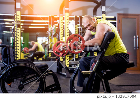 Disabled man training in the gym of rehabilitation center Disabled man training in the gym of rehabilitation center 132917004