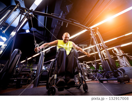 Disabled man training in the gym of rehabilitation center Disabled man training in the gym of rehabilitation center 132917008