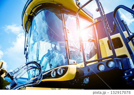 Modern agricultural machinery and equipment. Yellow agricultural harvester. Modern agricultural machinery and equipment. Yellow agricultural harvester. 132917078
