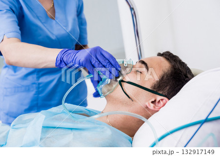 Doctors give resuscitation to a male patient in the emergency room. 132917149
