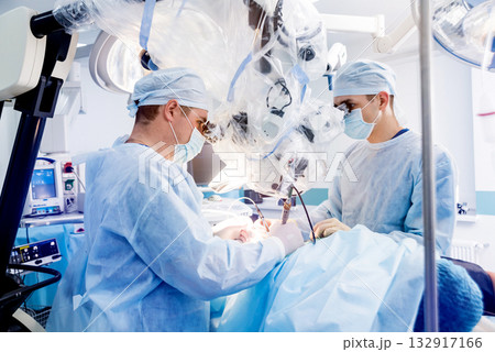 Spinal surgery. Group of surgeons in operating room with surgery equipment. Spinal surgery. Group of surgeons in operating room with surgery equipment. 132917166