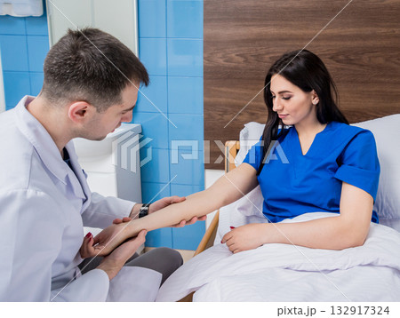 Traumatologist examining patient hands in modern hospital 132917324