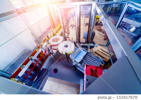 Automatic labeling machine during operation. Factory for the production  132917670