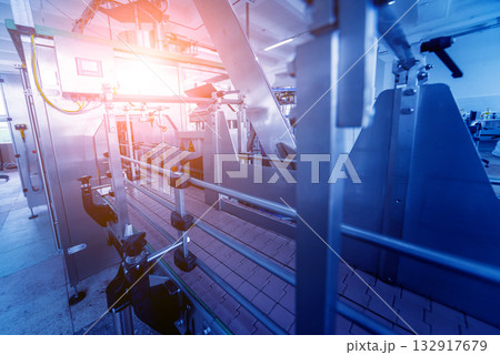 Bottling line of sunflower oil in bottles. Vegetable oil production plant. Bottling line of sunflower oil in bottles. Vegetable oil production plant. 132917679