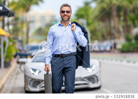Businessman hold briefcase. Mature businessman in suit. Corporate business. Luxury businessman in suit. Business leadership. Successful businessman walking with briefcase at parking 132918838