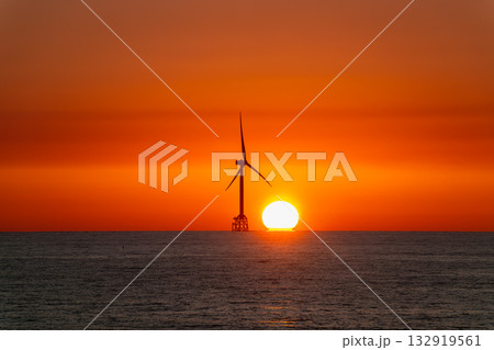 Sunset behind a wind turbine at Miaoli coastline in Taiwan. 132919561