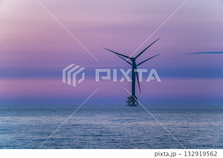 Tranquil sunset over Miaoli coastline with an offshore wind turbine. 132919562