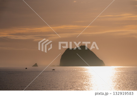 Fishing boat sailing near Keelung Islet at Waimushan during sunrise. Fishing boat sailing near Keelung Islet at Waimushan during sunrise. 132919583