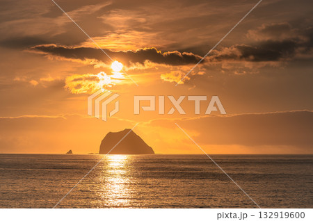 Golden sunrise over Keelung Islet and Waimushan coastline in Taiwan. Golden sunrise over Keelung Islet and Waimushan coastline in Taiwan. 132919600