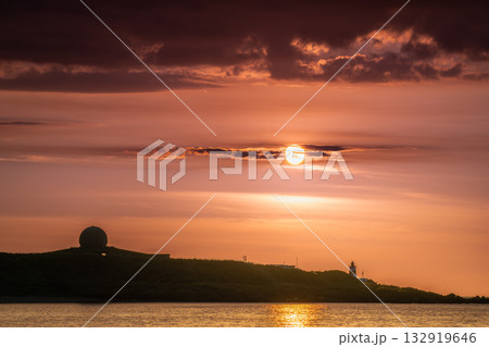 Dreamy Sunset Over Shimen Taiwan with Lighthouse and Moving Clouds. Dreamy Sunset Over Shimen Taiwan with Lighthouse and Moving Clouds. 132919646