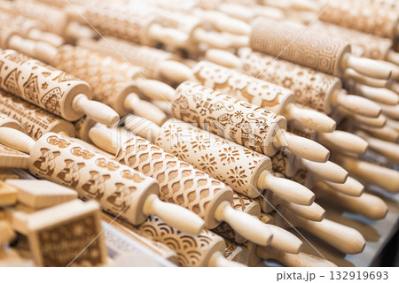 Wooden rolling pins for decorative dough are sold in a display case at a Christmas market 132919693