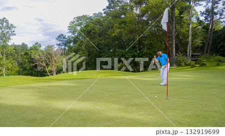 Golfer playing golf in the evening golf course, on sun set evening time. Golfer playing golf in the evening golf course, on sun set evening time. 132919699